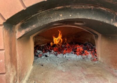 Traditional wood-fried pizza oven and shared patio | Thatch Close Cottages