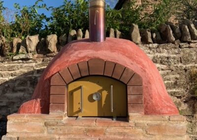 Traditional wood-fried pizza oven and shared patio | Thatch Close Cottages